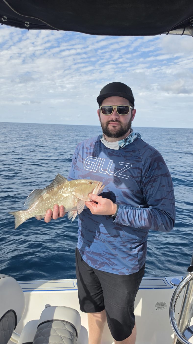 Guest with a grouper offshore