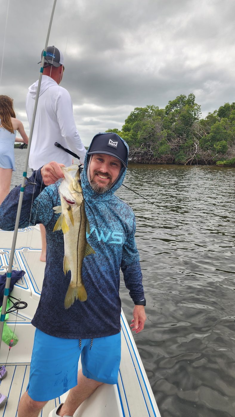 Guest with a snook near the mangroves